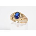 A 9CT GOLD GENTLEMENS SIGNET RING, designed with a central oval cut blue stone assessed as paste
