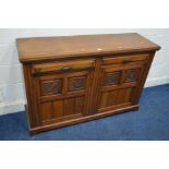 AN EDWARDIAN WALNUT SIDEBOARD with two drawers above double floral panel doors, width 137cm x