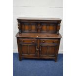 A DARK ERCOL COURT CUPBOARD, with two drawers, approximate width 124cm x depth 34cm x height 125cm