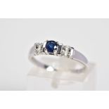 A 9CT WHITE GOLD SAPPHIRE AND DIAMOND RING, designed with a central claw set circular cut