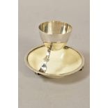 A GEORGE V SILVER AND CERAMIC EGG CUP ATTRIBUTED TO A DESIGN BY CHRISTOPHER DRESSER, silver makers