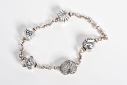 A SILVER PANDORA CHARM BRACELET, the curb link bracelet with four charms such as a colourless