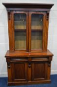 A VICTORIAN WALNUT GLAZED DOUBLE BOOKCASE, on a married base with two drawers, width 121cm x depth
