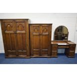 A REPRODUCTION OAK THREE PIECE BEDROOM SUITE, with carved arches and pillars to panels, comprising a