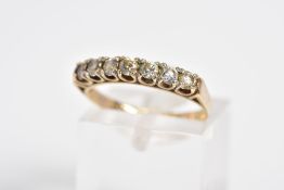 A 9CT GOLD CUBIC ZIRCONIA HALF ETERNITY RING, designed with seven claw set circular cut cubic