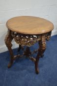 A REPRODUCTION HEAVILY CARVED ROUND CENTRE TABLE with a pierced foliate frieze, foliate carved