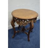 A REPRODUCTION HEAVILY CARVED ROUND CENTRE TABLE with a pierced foliate frieze, foliate carved