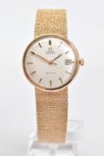 A 9CT GOLD OMEGA AUTOMATIC GENEVE WRISTWATCH, a silvered dial with gold coloured baton markers and