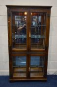 AN OLD CHARM OAK LEAD GLAZED FOUR DOOR BOOKCASE, with glass shelves, width 91cm x depth 33cm x