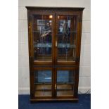 AN OLD CHARM OAK LEAD GLAZED FOUR DOOR BOOKCASE, with glass shelves, width 91cm x depth 33cm x