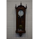 A LATE 19TH CENTURY WALNUT AND EBONISED VIENNA WALL CLOCK, the 7'' enamel dial with Roman numerals