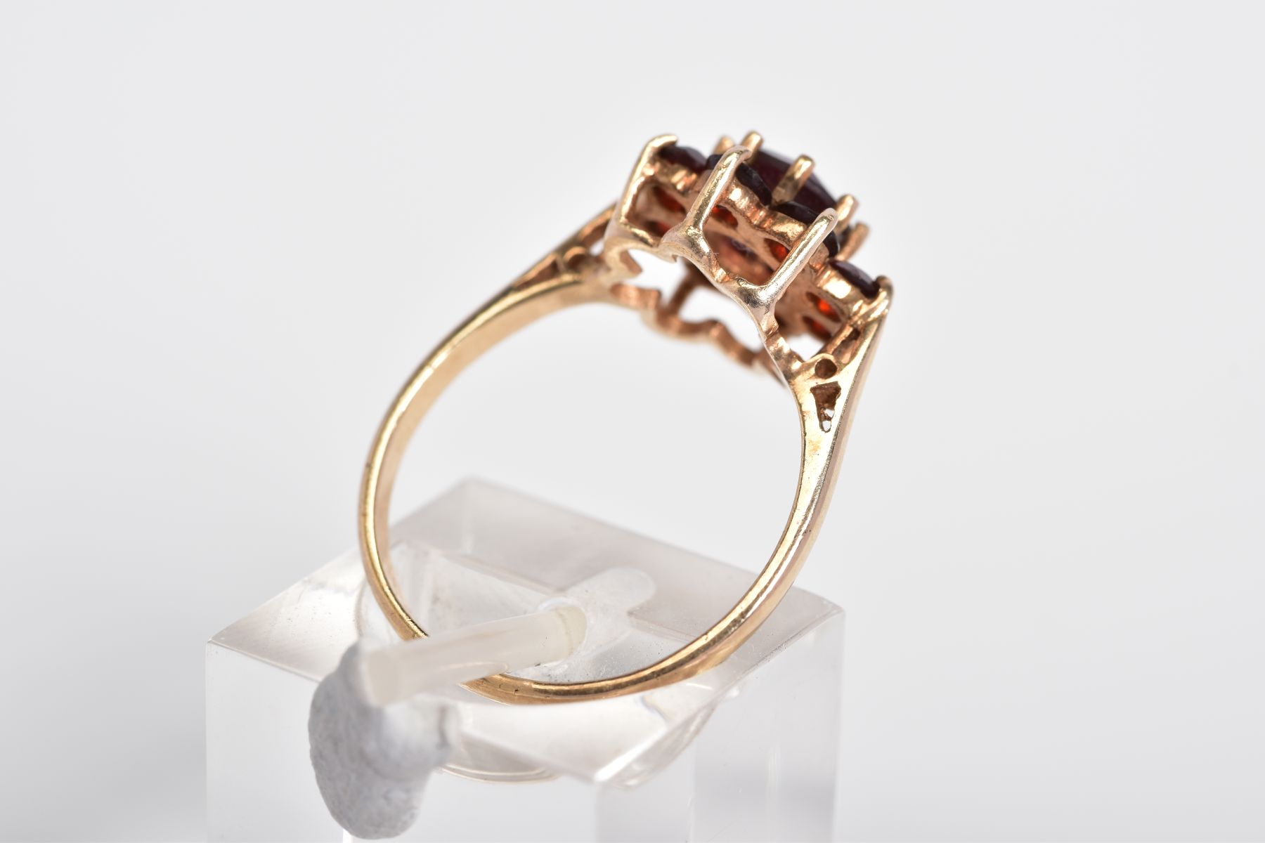 A GARNET CLUSTER RING, designed with a raised cluster set with nine circular cut garnets, to the - Image 3 of 3