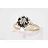 A 9CT GOLD SAPPHIRE AND DIAMOND CLUSTER RING, the raised cluster set with a central single cut