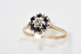 A 9CT GOLD SAPPHIRE AND DIAMOND CLUSTER RING, the raised cluster set with a central single cut