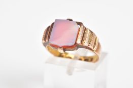 A 15CT GOLD SIGNET RING, designed with a carnelian square panel to the textured shoulders and