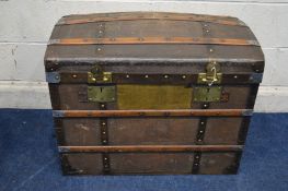 A VINTAGE WOODEN AND METAL BANDED DOMED TOPPED TRUNK, with two internal tray and twin metal drop