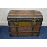 A VINTAGE WOODEN AND METAL BANDED DOMED TOPPED TRUNK, with two internal tray and twin metal drop