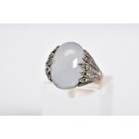 A MOONSTONE CABOCHON RING, the yellow metal ring designed with an oval cut cabochon moonstone,