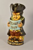 A WILLIAM AULT TOBY JUG, modelled standing reading a paper titled 'Peace 1919', the circular base