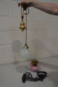A MID 20TH CENTURY BRASS RISE AND FALL SINGLE LIGHT FITTING, with glass shade, together with a