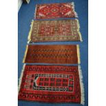 FOUR VARIOUS 20TH CENTURY WOOLEN RUGS, all red ground including one tekke rug, each rug sizes
