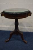 A MODERN MAHOGANY DRUM TABLE with pie crust edge covered with glass, two frieze drawers, turned