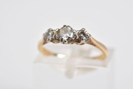 A THREE STONE DIAMOND RING, the yellow metal ring set with three graduated round brilliant cut