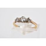 A THREE STONE DIAMOND RING, the yellow metal ring set with three graduated round brilliant cut