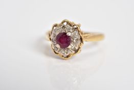 A RUBY AND DIAMOND CLUSTER RING, designed with a central circular cut ruby with single cut diamond