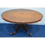 A LATE VICTORIAN MAHOGANY AND WALNUT OVAL LOO TABLE, on a scrolled base, approximate width 135cm x