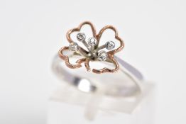 A 9CT WHITE GOLD AND DIAMOND RING, designed with an openwork flower with rose gold leaves, set