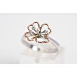 A 9CT WHITE GOLD AND DIAMOND RING, designed with an openwork flower with rose gold leaves, set