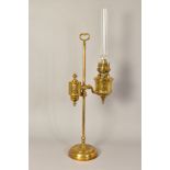 A LATE 19TH/EARLY 20TH CENTURY FRENCH BRASS OIL LAMP, on a height adjustable column with carrying