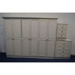 A CREAM AND GILT BEDROOM SUITE, comprising a six door wardrobe, splits into three sections but