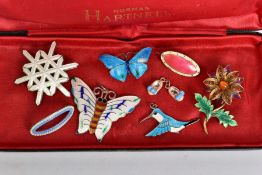 EIGHT PIECES OF ENAMELLED SILVER JEWELLERY IN A NORMAN HARTNELL CASE, including a white snowflake