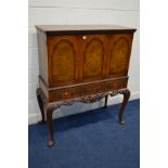 A REPRODUCTION MAHOGANY AND BURR WALNUT TRIPLE DOOR DRINKS CABINET, two internal sections with