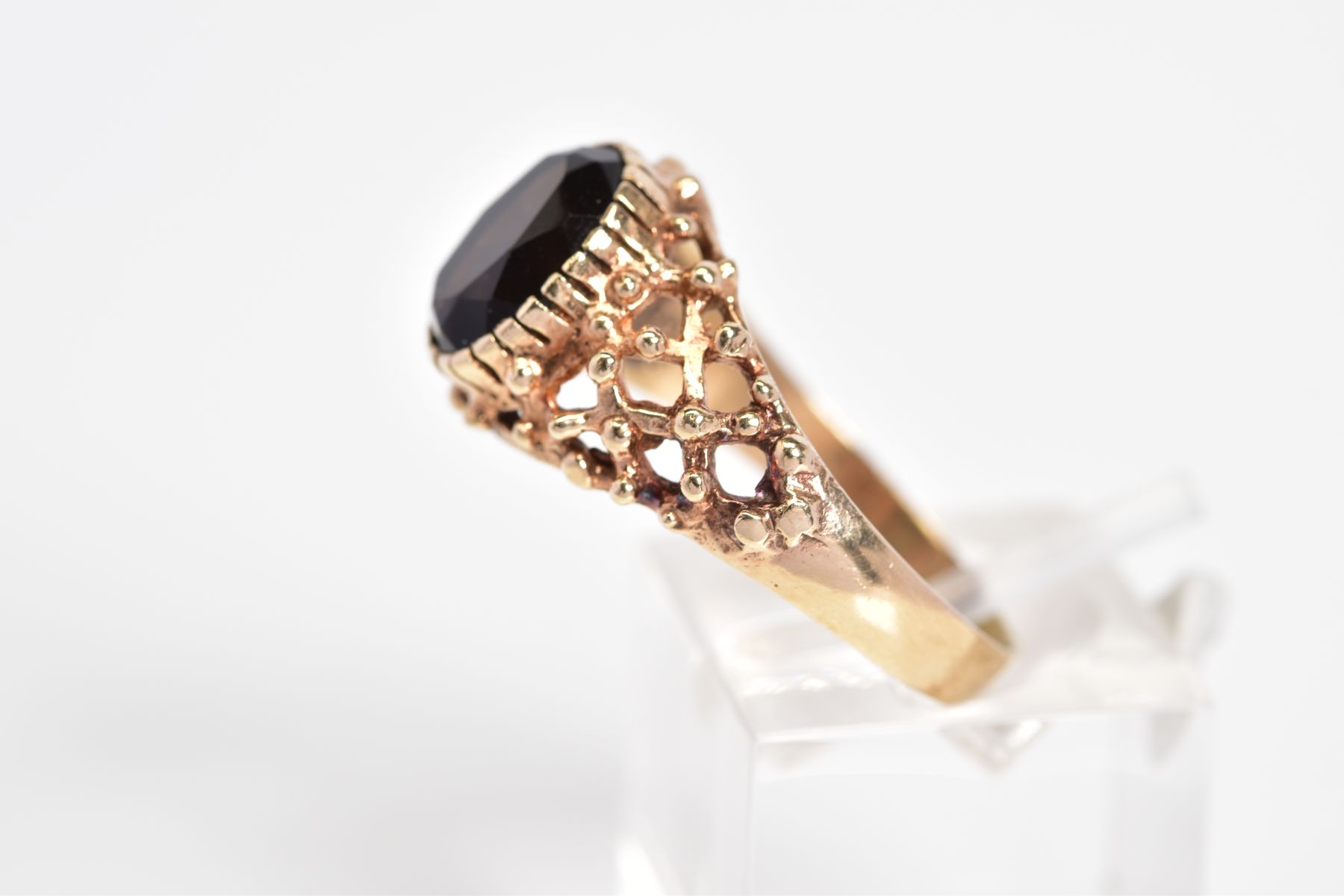 A 9CT GOLD SMOKEY QUARTZ RING, designed with a claw set oval cut smokey quartz and open work - Image 2 of 3