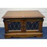 AN OLD CHARM OAK LEAD GLAZED TWO DOOR TV STAND, approximate width 77cm x depth 49cm x height 45cm