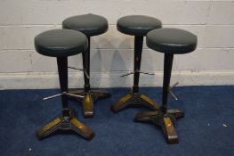 A SET OF FOUR MODERN ART DECO STYLE CAST IRON BAR STOOLS with brassed feet on a triangular section