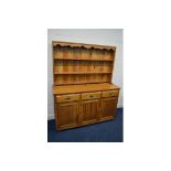 A MODERN PINE DRESSER, with three drawers, width 152cm x depth 52cm x height 184cm