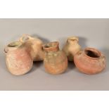 FIVE ANCIENT ROMAN TERRACOTTA JUGS, of varying forms, heights range from 14cm - 22cm (5)
