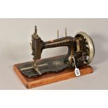 A LATE 19TH CENTURY UN-NAMED SEWING MACHINE, on a fiddle shaped base with abalone shell inlay and