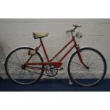 A VINTAGE RED LADIES BICYCLE with a Brooks sadle (sd and rusted)