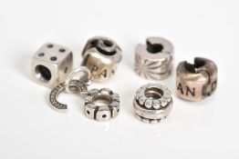 A COLLECTION OF SIX PANDORA CHARMS, to include a dice, letter C initial set with colourless paste,