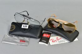 TWO PAIRS OF RAY-BAN GLASSES, both of out doorsmandesign, the first with a black frame and clear