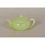 A SMALL CHINESE GREEN HARDSTONE TEAPOT, with loop handle, height 5cm (chip to rim)
