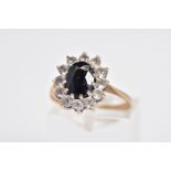 A 9CT GOLD SAPPHIRE CLUSTER RING, the raised cluster designed with a claw set oval cut sapphire