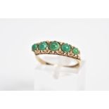 AN EARLY 20TH CENTURY 9CT GOLD RING, set with five graduated circular cut cabochon turquoise, within
