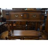 A REPRODUCTION MELLOWCRAFT OAK SIDE TABLE with two drawers on turned front legs, width 122cm x depth