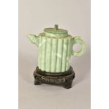 A 20TH CENTURY CARVED GREEN HARDSTONE DECORATIVE TEA POT, of bamboo form, height 8.5cm, together
